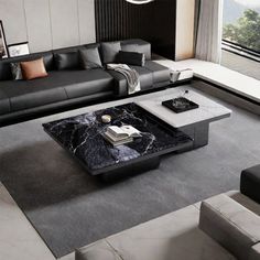 a black and white living room with couches, coffee table and large window overlooking the mountains