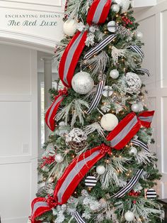 a christmas tree decorated with red, white and silver ornaments