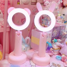 there are two pink lights on top of each other in front of some stuffed animals