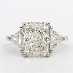 a three stone diamond ring set in 18k white gold with an old european cut diamond