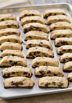 a pan filled with chocolate chip cookies on top of a table