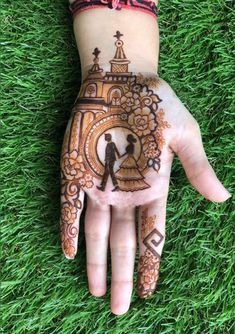 a person's hand painted with hennap on the grass and an image of a