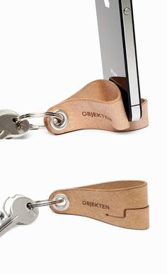 a cell phone is attached to a leather keychain