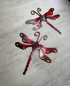 three metal flowers sitting on top of a table