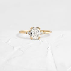 an engagement ring with a cushion cut diamond