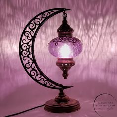 a purple lamp with a crescent on it