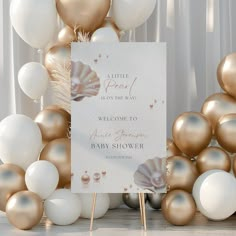 a welcome sign surrounded by gold and white balloons