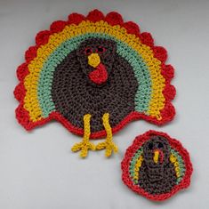 two crocheted turkey placemats on a white surface