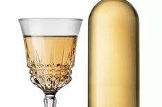 a wine glass and bottle are next to each other on a white background with an empty bottle in the foreground