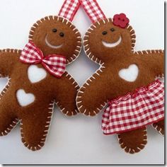 two brown teddy bears hanging from a red and white checkered ribbon