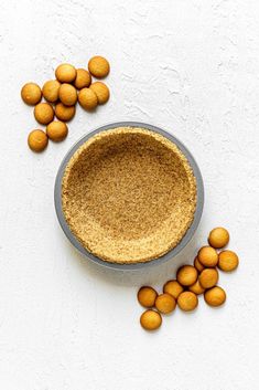 a bowl filled with almonds next to it on top of a white tablecloth