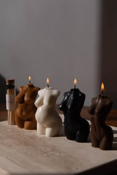 three candles sitting on top of a wooden table