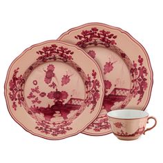 three plates and two cups with red flowers on the rim, one has a saucer