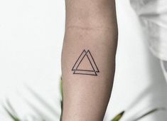 a small triangle tattoo on the arm