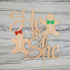 there is a cake topper with two gingerbreads and the words hello she