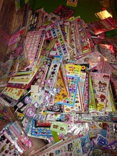 many different types of stickers are on the floor together in this pile, and there is no image here to provide a caption