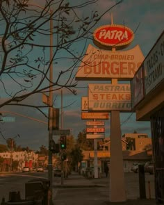 a burger restaurant sign on the corner of a street