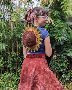 a woman in a skirt with a sunflower on her back