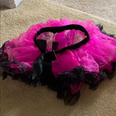 a pink and black dress laying on the floor