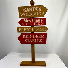 a wooden sign sitting on top of a white table