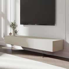 a flat screen tv mounted to the side of a wall in a white living room