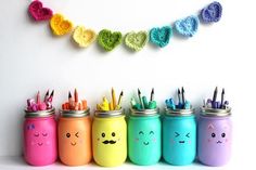 there are many different colored pencils in the same jar and one has a smiley face on it