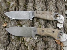 two knives sitting on top of a tree