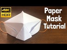 an origami paper mask is shown with the words, paper mask tutorial