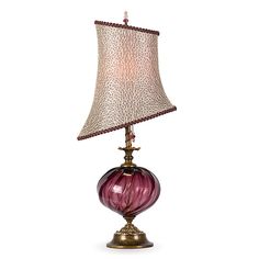 a purple lamp with a white shade on it's side and a pink base