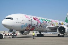 an airplane with hello kitty painted on it's side is parked at the airport