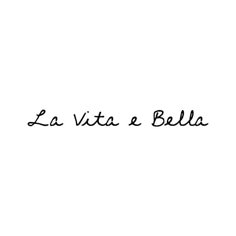 the words la vita a bella written in black ink