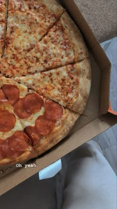 a large pepperoni pizza in a cardboard box