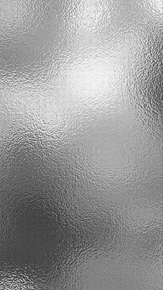 an abstract silver metallic background with some light reflections on the metal surface and it looks like something out of space