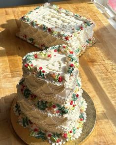 two wedding cakes sitting on top of a wooden table