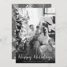 a holiday card with an image of two people and a christmas tree in the background