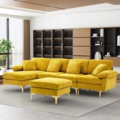 a living room with a large yellow sectional couch and matching footstool in front of a bookshelf