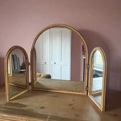 a mirror sitting on top of a wooden dresser