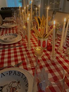 the table is set with candles and plates