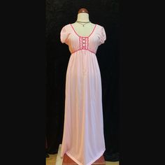 Vintage pastel pink long nightgown.  Shoulder cap sleeves  Magenta trim around neckline and bust.  Three magenta buttons down the bust.  This beauty had two tiny holes on the front in which I put two tiny floral appliqués to cover.  To sweet not to list.  Women's size Large Please ask for measurements if interested.  Thank you. Pink V-neck Nightgown With Lace Trim, Pink Lace Trim Dresses For Bedtime, Pink Short Sleeve Nightgown For Spring, Fitted Short Sleeve Nightgown With Lace Trim, Pink Short Sleeve Sleepwear With Lace Trim, Vintage Pink V-neck Nightgown, Vintage Pink Sleep Dresses, Pink Fitted V-neck Nightgown, Feminine Pink Short Sleeve Nightgown