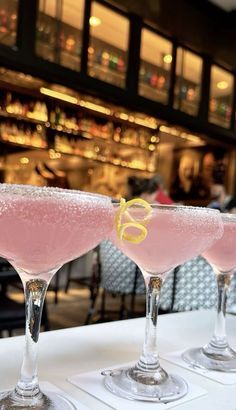 three martinis sitting on top of a white table