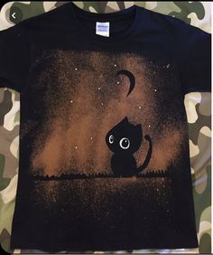 a t - shirt with a black cat on it