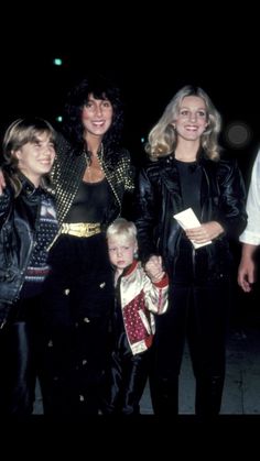 two women and a child are posing for the camera