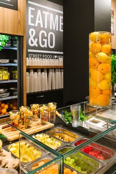 an assortment of fruits and vegetables on display in a grocery store's deli