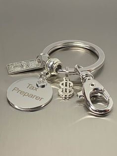 a metal keychain with two different types of personalized items attached to it