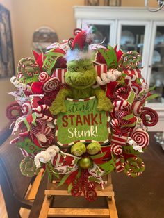 a christmas wreath with the words you're stank stink on it and candy canes