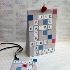 a father's day crossword puzzle card with a red heart on it and a black string