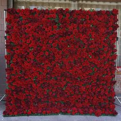 a large red flowered wall in front of a building