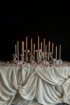 a table topped with lots of lit candles