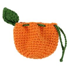 an orange crocheted purse with a green leaf on the top and bottom part