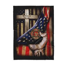 an american flag with a fireman's emblem on it and a cross in the background